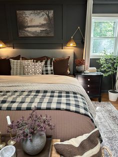 a bedroom with a large bed and checkered comforter on top of the bed