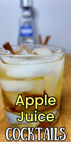 an apple juice cocktail in a glass with ice and cinnamon sticks