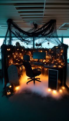 an office decorated for halloween with lots of lights on the desk and decorations around it