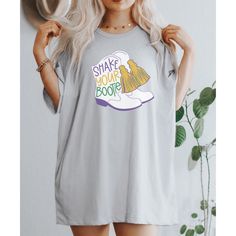 a woman with blonde hair wearing a t - shirt that says shake your booties