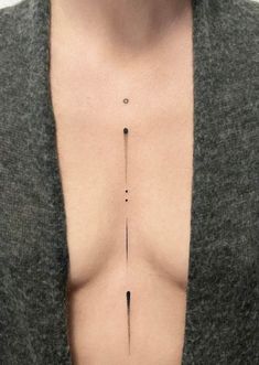 a man with an arrow tattoo on his chest is shown from the neck to the chest