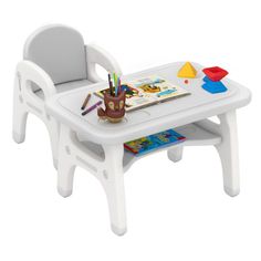 a white plastic table with a book and pencils on it next to a toy chair