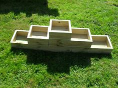 several wooden trays sitting in the grass