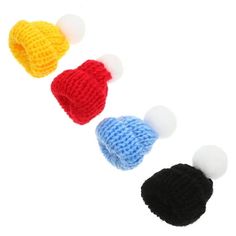 three crocheted hats with white, black, and blue balls in them on a white background