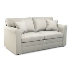 a white couch with some pillows on it's back and the seat upholstered