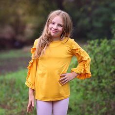 This girls ruffled 3/4 sleeved shirt takes your basic tee to the next level. Not only is it cute, but super comfy! - 100% polyester  We recommend hand washing and hang drying this article of clothing. Ruffled Shirt, Twirly Dress, Yellow Shirt, Girls Shirt, Girls Blouse, Yellow Shirts, Ruffle Shirt, Star Girl, School Shirts