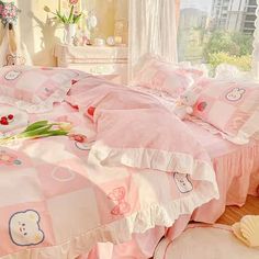 a bedroom with hello kitty bedding and pink comforter