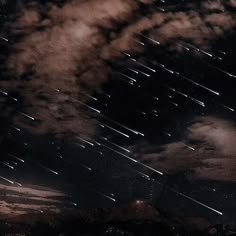 the night sky is filled with stars as well as clouds and some dark colored clouds