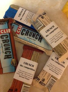 some candy bars are laying on the floor together and have labels attached to them that say crunch