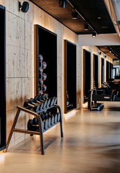 there are many pairs of shoes on the bench in this room, all lined up against the wall