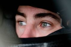 a close up of a person's face with the hood over their head looking into the camera