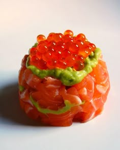 an orange fruit with green and red toppings