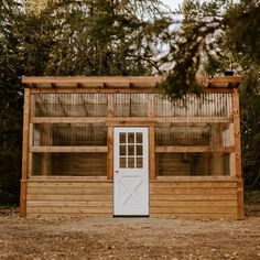 a wooden building with a white door and windows