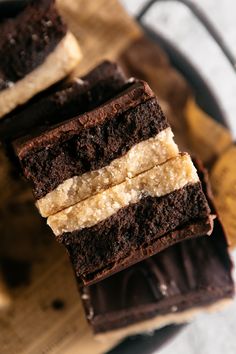 three pieces of cake sitting on top of a wooden cutting board next to banana peels