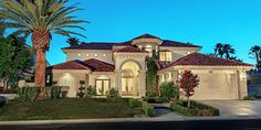 a large house with palm trees in front of it