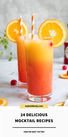 two glasses filled with orange juice next to sliced oranges and garnishes