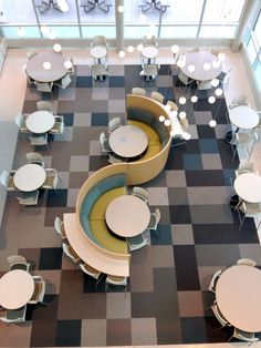 an overhead view of tables and chairs in a room with checkerboard flooring