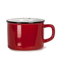 a red coffee mug sitting on top of a white table next to a black lid