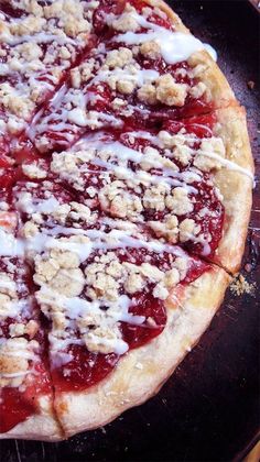 a close up of a pizza with toppings on it's crust and cheese