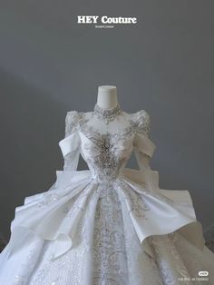 a white wedding dress on display with the words hey couture written above it