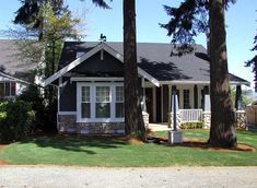 a house with trees and grass in front of it