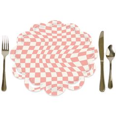 a pink and white checkered placemat with silverware next to it on a white surface