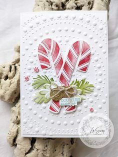 a christmas card with candy canes on it