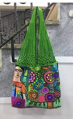 a green purse hanging from the side of a stair case