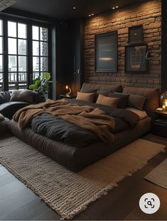 a large bed sitting in the middle of a living room next to a brick wall