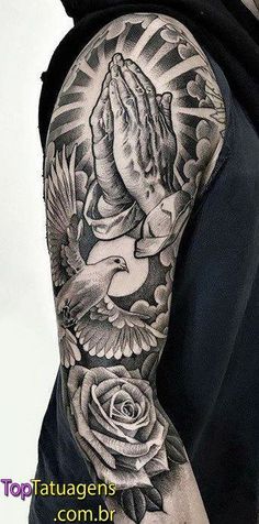 a man with a black and white tattoo on his arm is holding a dove in the air