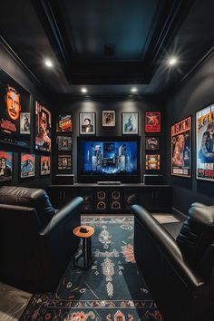 a home theater with black leather chairs and pictures on the wall