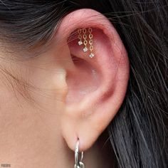 a close up of a person with ear piercings