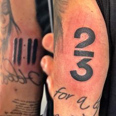 two men with numbers tattooed on their arms, one for each and the other for all