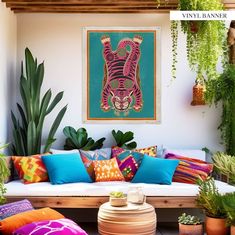 a living room filled with lots of different colored pillows and plants on top of it