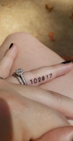 a woman's hand with a ring on her finger that has the date 1911 written on it