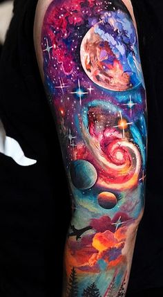 a man with a colorful tattoo on his arm and shoulder that has an image of planets in the sky