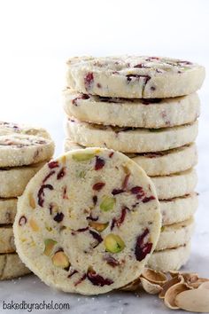 several cookies stacked on top of each other next to a pile of nuts and almonds