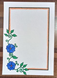 a card with blue flowers and green leaves on the edge, in front of a bamboo mat