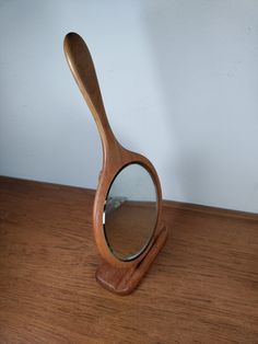 a magnifying glass sitting on top of a wooden table