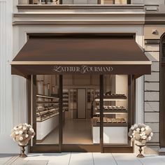 a store front with an awning and flowers outside