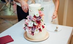 the bride and groom are cutting their wedding cake