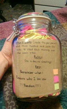 a hand holding a jar filled with colorful sticky notes and writing on the inside of it