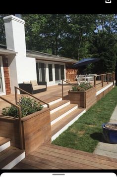 a deck with planters on it and stairs leading up to the back yard area