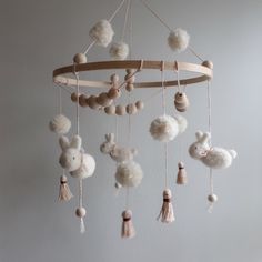 a mobile with pom poms hanging from it's sides