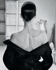 the back of a woman's head and shoulders, in black and white photo