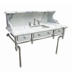 a white marble sink with two faucets on it