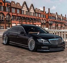 a black car parked in front of some buildings