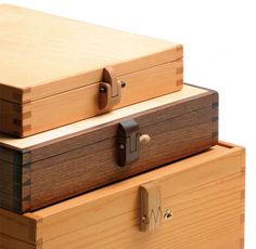 two wooden boxes stacked on top of each other with one open and the other closed