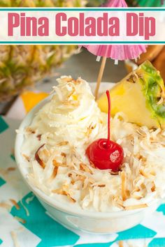 pineapple and coconut drink topped with whipped cream in a bowl