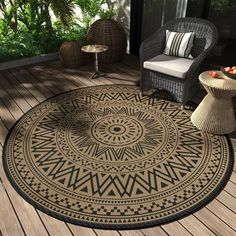 an outdoor area rug with a chair and table